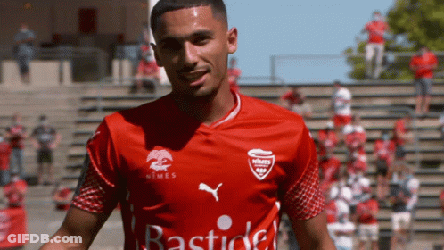 A Man Wearing A Red Shirt That Says Bastide GIF