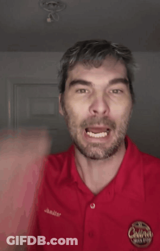 A Man Wearing A Red Shirt That Says Bitch On It GIF