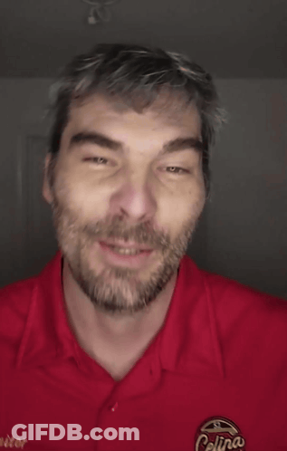 A Man Wearing A Red Shirt That Says Colin 'S On It GIF
