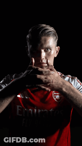 A Man Wearing A Red Shirt That Says Emirates GIF