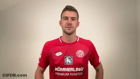 A Man Wearing A Red Shirt That Says Kommerling Premium Fenster On It GIF
