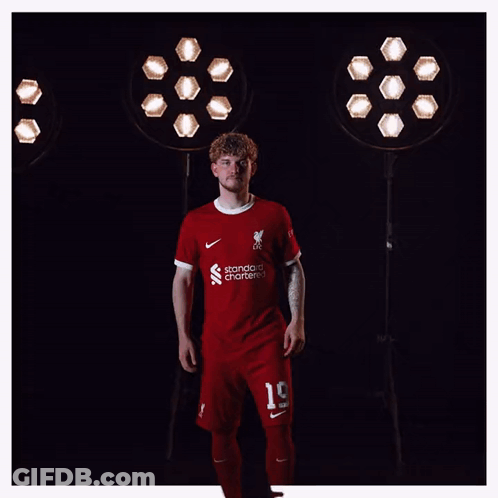A Man Wearing A Red Shirt That Says Liverpool On It GIF