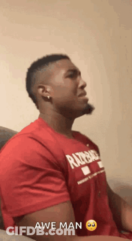 Man In Razorback Shirt Sitting On Couch GIF