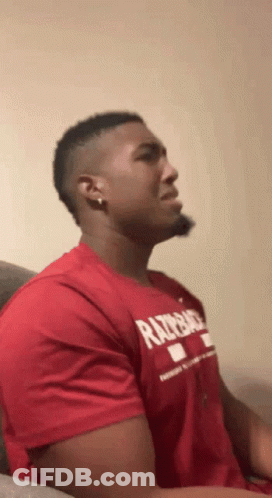 Man In Red Razorback Shirt Sitting On Couch GIF