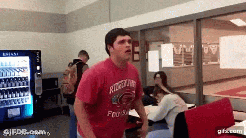 A Man Wearing A Red Shirt That Says Ridgerunner Football GIF