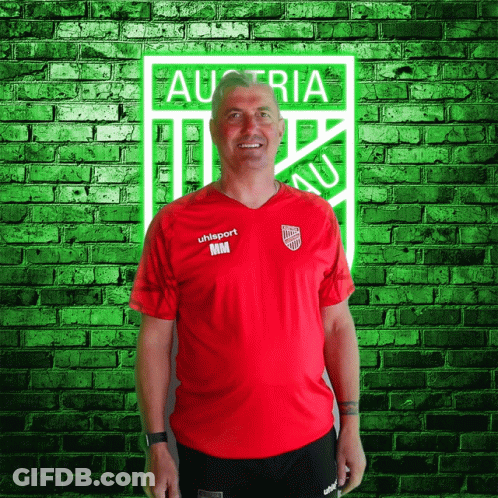 A Man Wearing A Red Shirt That Says Uhlsport GIF