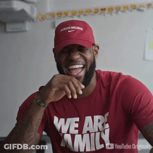 A Man Wearing A Red Shirt That Says We Are Family Is Laughing GIF