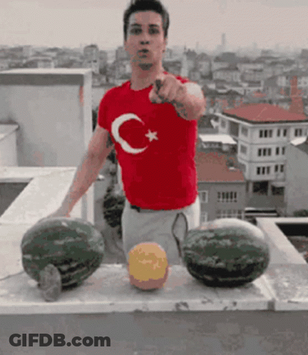 A Man Wearing A Red Shirt With A Crescent Moon And Star On It GIF