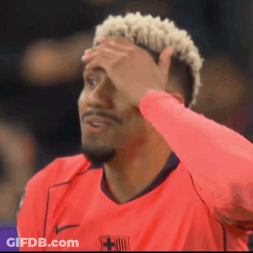 A Man Wearing A Red Shirt With A Fcb Logo On The Front GIF