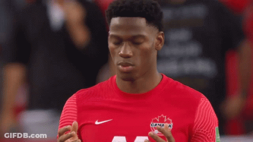 A Man Wearing A Red Shirt With A Maple Leaf On It GIF