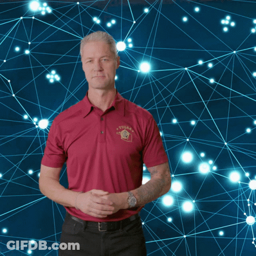 A Man Wearing A Red Shirt With A Texas Logo On It GIF