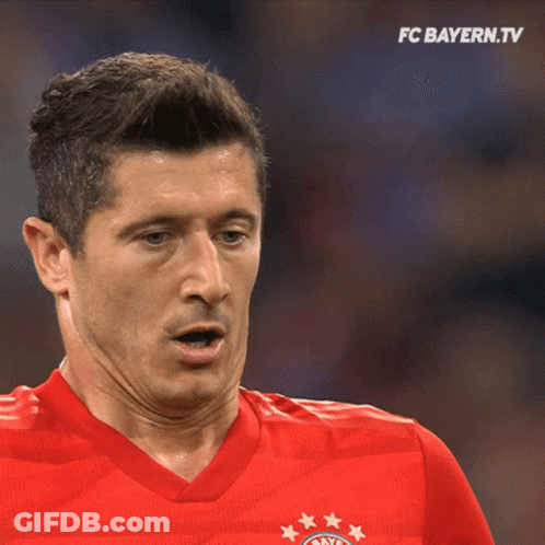 A Man Wearing A Red Shirt With The Fc Bayern Logo GIF