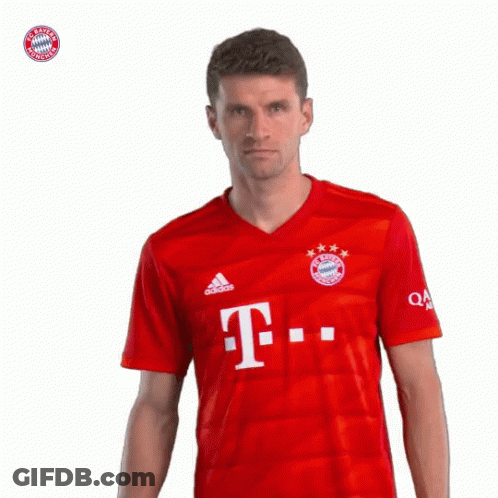 A Man Wearing A Red Shirt With The Letter T On The Front GIF
