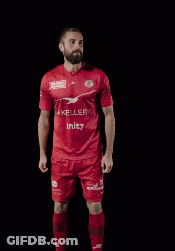 A Man Wearing A Red Shirt With The Number 23 On It GIF