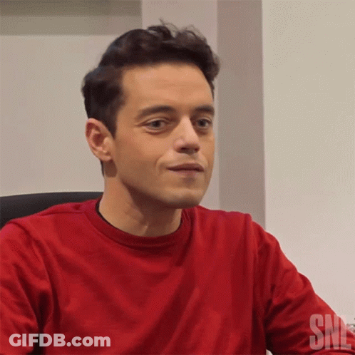 A Man Wearing A Red Shirt With The Word Snl On The Bottom GIF