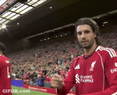 A Man Wearing A Red Shirt With The Word Standard On It GIF