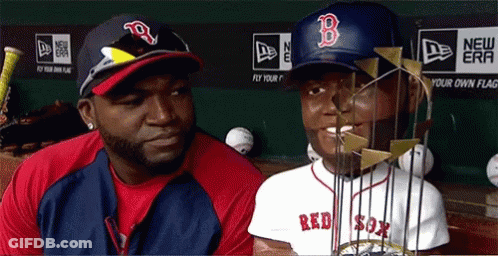 A Man Wearing A Red Sox Hat Stands Next To A Man Wearing A Red Sox Jersey GIF