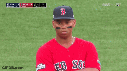 A Man Wearing A Red Sox Jersey Stands On A Baseball Field GIF