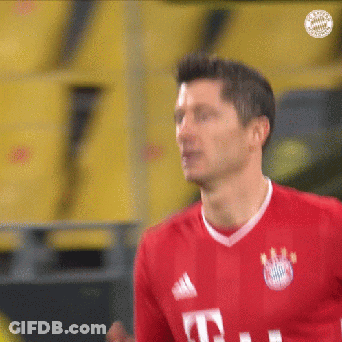 A Man Wearing A Red T-Mobile Jersey Looks At Something GIF