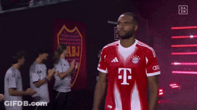 A Man Wearing A Red T-Mobile Jersey Stands In Front Of A Sign That Says Abj GIF