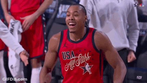 A Man Wearing A Red Usa All Stars Jersey Is Smiling GIF