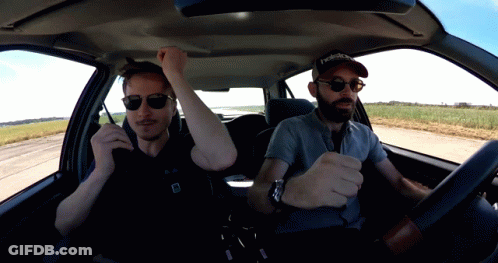 A Man Wearing A Reebok Hat Sits In A Car With Another Man GIF
