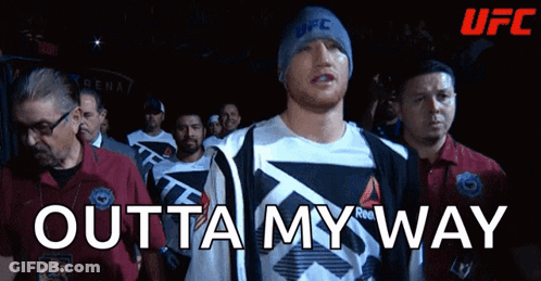 A Man Wearing A Reebok Shirt Walks Into A Ufc Ring GIF