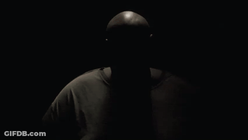 A Man Wearing A Reebok T-Shirt Is Looking At The Camera GIF