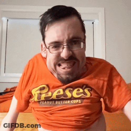 A Man Wearing A Reese 'S Peanut Butter Cups Shirt GIF