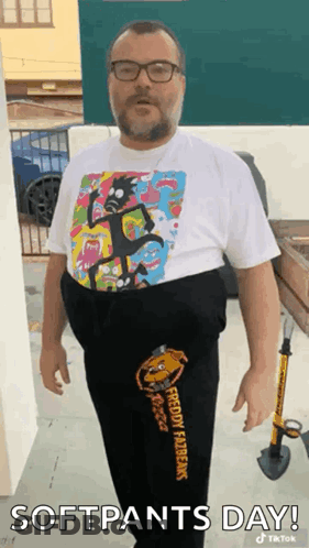 A Man Wearing A Rick And Morty Shirt And Sweatpants Is Standing In Front Of A Building . GIF
