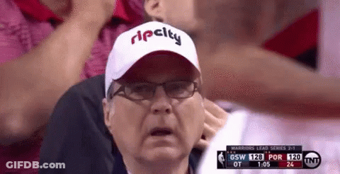 A Man Wearing A Rip City Hat And Glasses Is Watching A Basketball Game GIF