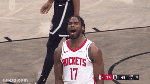 A Man Wearing A Rockets Jersey Stands On The Court GIF
