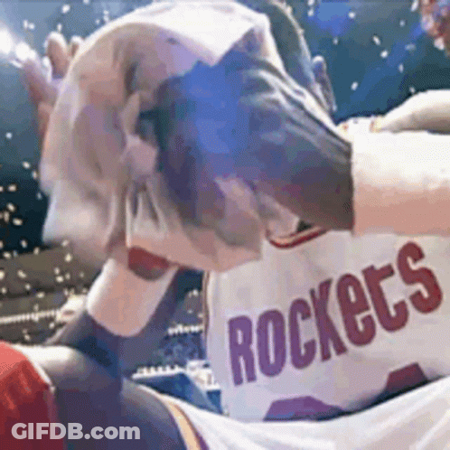 A Man Wearing A Rockets Jersey Wipes His Face GIF