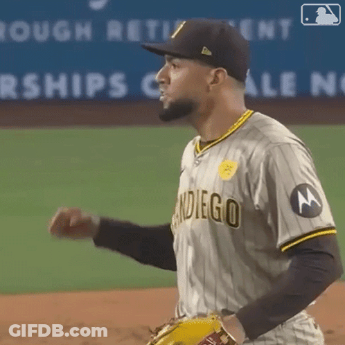 A Man Wearing A San Diego Baseball Uniform Is Standing On A Baseball Field GIF