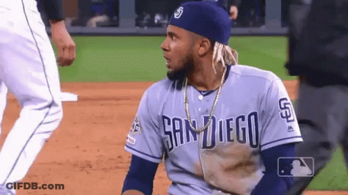 A Man Wearing A San Diego Jersey Is Sitting On The Baseball Field GIF