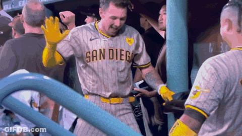 A Man Wearing A San Diego Jersey Stands In The Dugout GIF