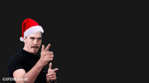A Man Wearing A Santa Hat And A Shirt That Says Coach On It GIF