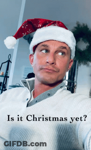 A Man Wearing A Santa Hat Is Asking If Christmas Is Yet GIF