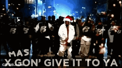 A Man Wearing A Santa Hat Is Dancing In Front Of A Crowd With The Words X Gon ' Give It To Ya GIF
