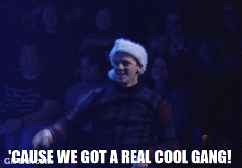 A Man Wearing A Santa Hat Is Standing In Front Of A Crowd And Says ' Cause We Got A Real Cool Gang ' GIF