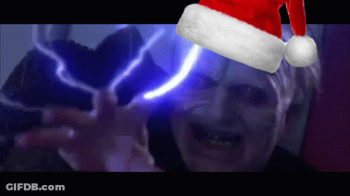 A Man Wearing A Santa Hat With A Light Behind Him GIF