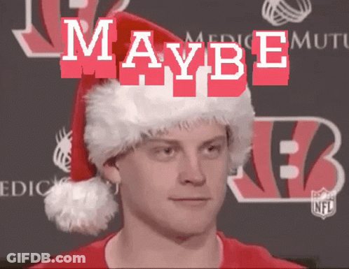 A Man Wearing A Santa Hat With The Word Maybe Written On It GIF