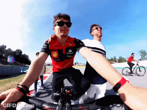A Man Wearing A Santander Shirt Rides A Bike GIF