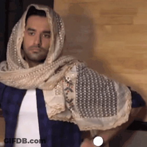 A Man Wearing A Scarf Around His Head And A Watch On His Wrist GIF