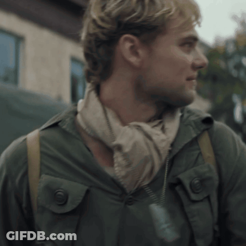 A Man Wearing A Scarf Around His Neck And A Jacket GIF