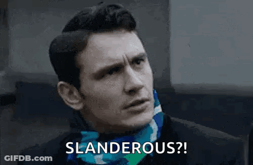 A Man Wearing A Scarf Around His Neck Is Making A Funny Face And Says Slanderous . GIF