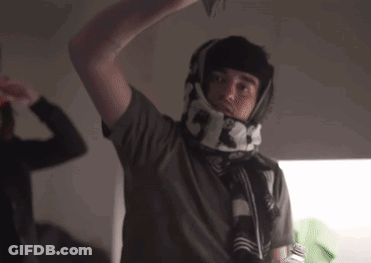 A Man Wearing A Scarf Around His Neck With The Numbers 5 And 3 On It GIF