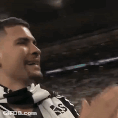 A Man Wearing A Scarf That Says Ras Is Clapping GIF