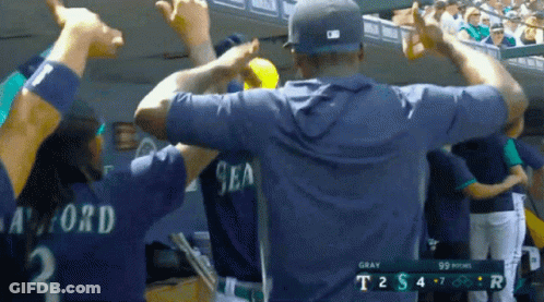 A Man Wearing A Sea Jersey Stands In The Dugout GIF