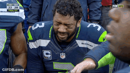 A Man Wearing A Seahawks Jersey Is Crying During A Game GIF
